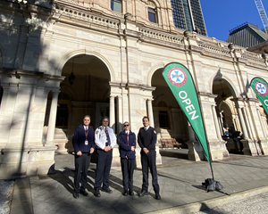 a group of people standing outside parliament house