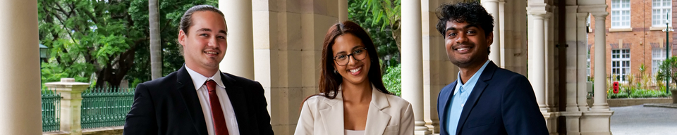 3 graduates looking in the camera smiling